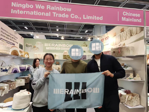 Trade show visitors with a WERAINBOW banner